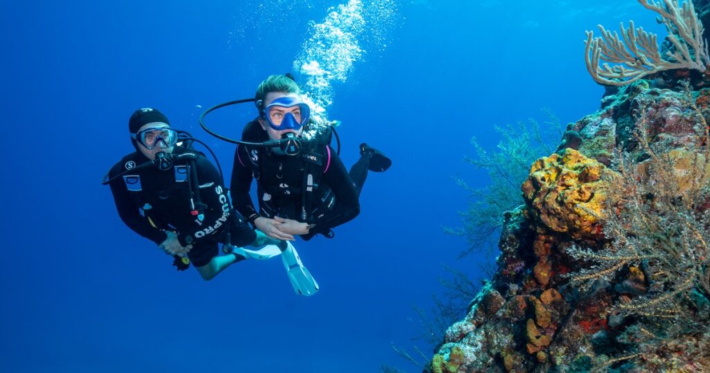 Superyacht Loon charter guests diving at Man-O-War Cay