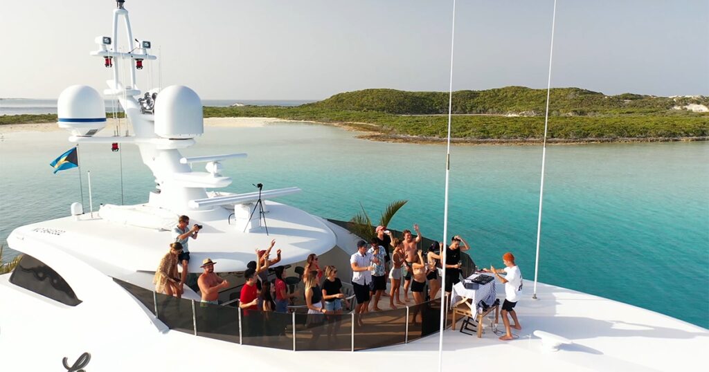 DJ and charter guests on the deck of Motor Yacht Loon
