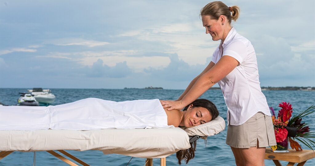 Charter Superyacht Loon Superyacht crew member gives massage to charter guest on MY Loon