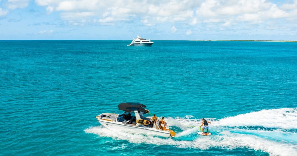 MY Loon with tender and water skiing charter guest in Barbuda