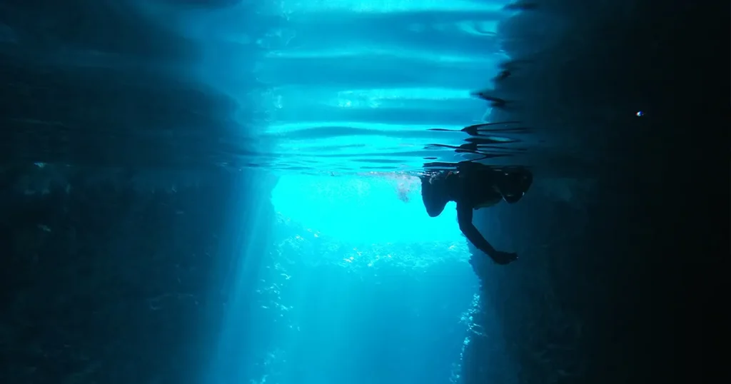 charter guests from superyacht Loon swimming in hidden caves