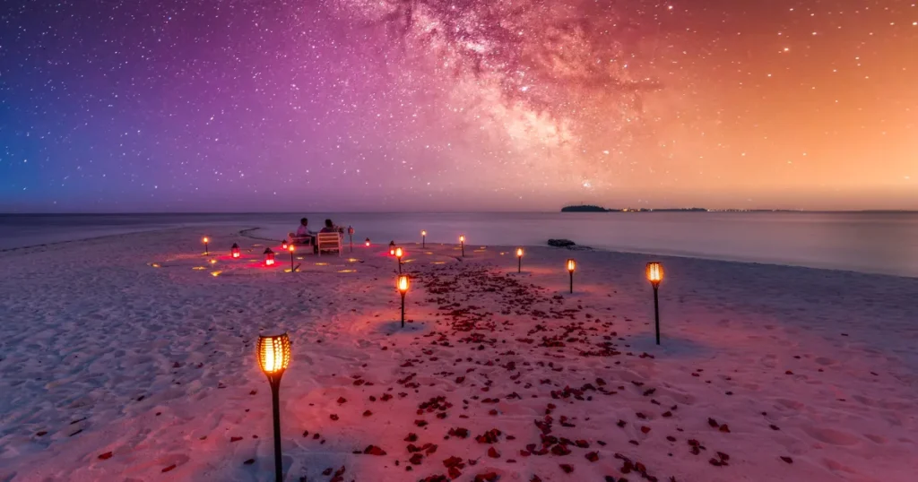 A beach set up for a celebration under a starry sky