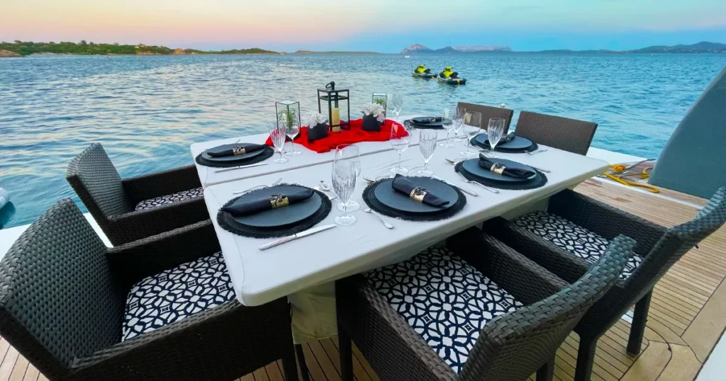 An intimate meal setting on the beach club of charter superyacht Loon